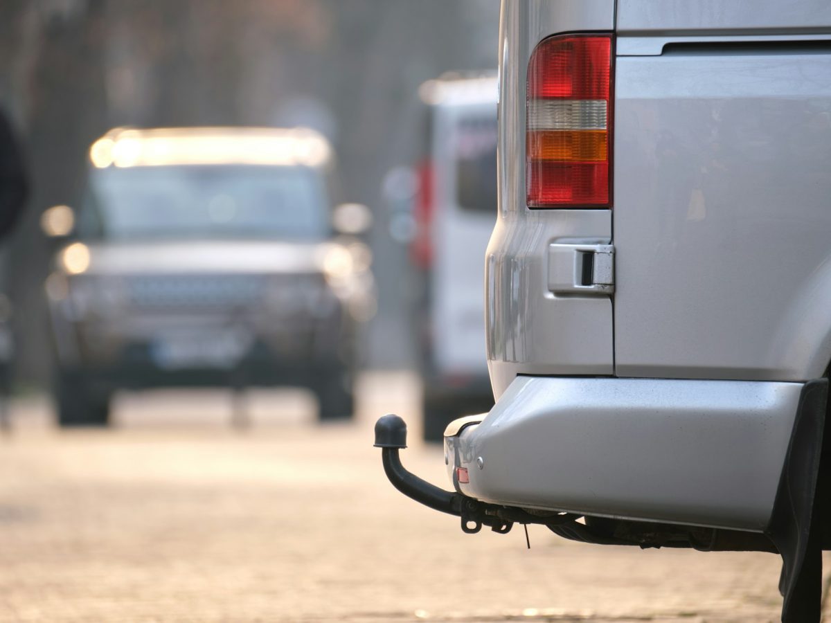 Close up of a van with tow hitch parked on city street side