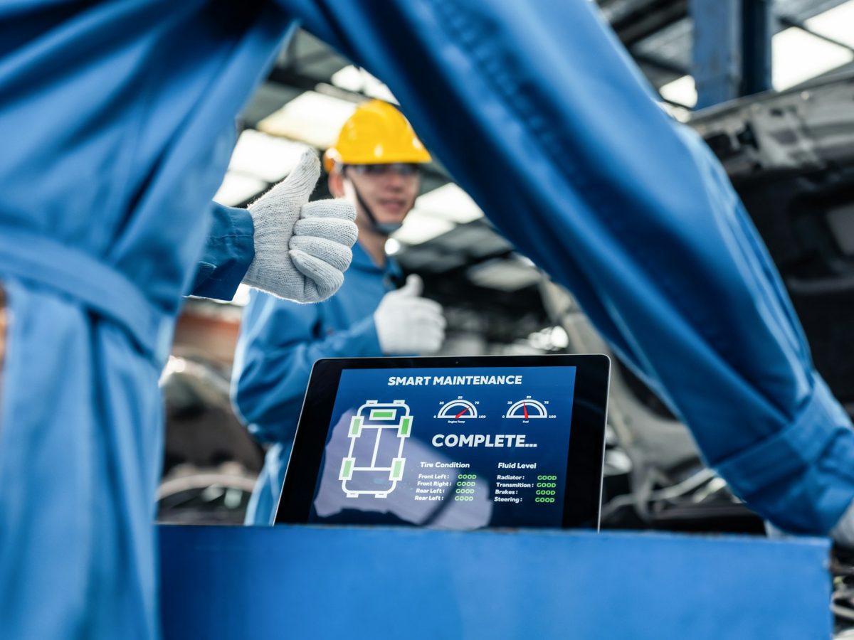 Close up of Automotive mechanic running diagnostics software on tablet.